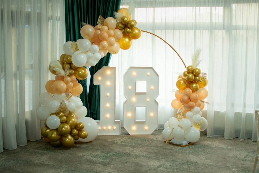 Illuminated number 18 with balloon decorations